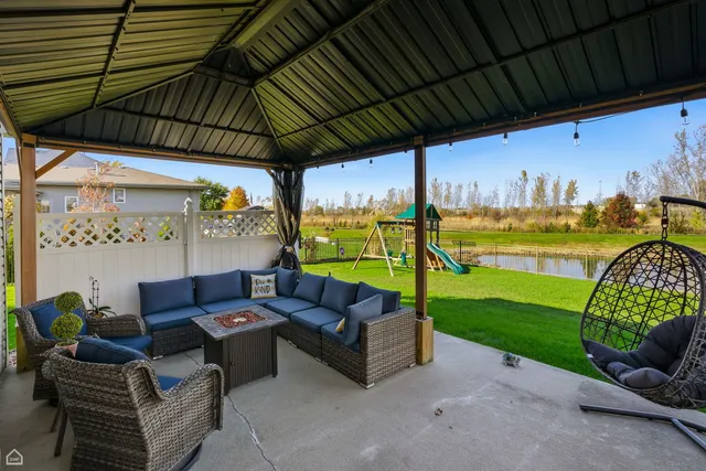 a view of a house with a backyard and a table