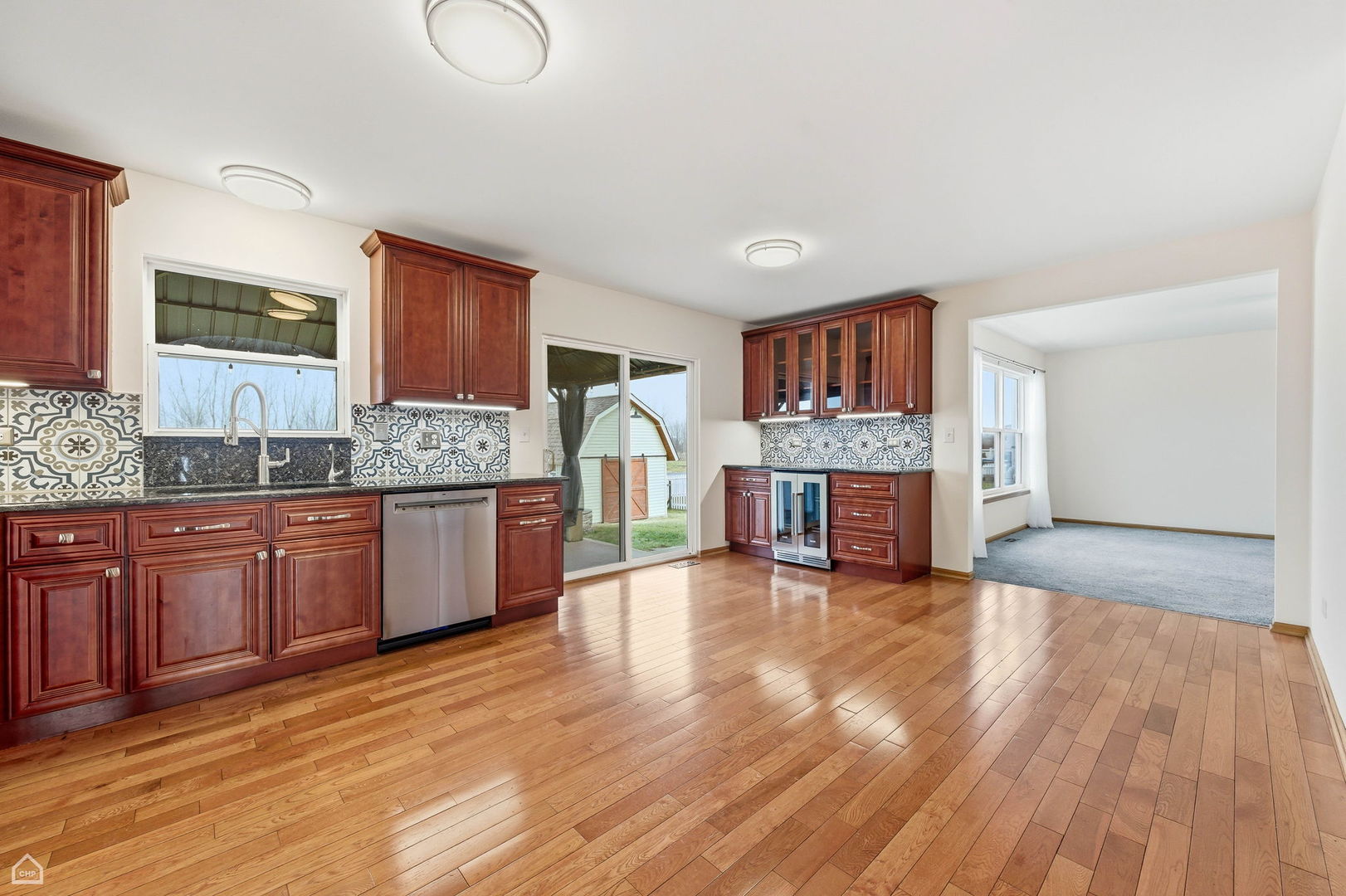 16353 Celtic Circle Manhattan, IL 60442 - Photo 6 of 23 a large kitchen with stainless steel appliances granite countertop a stove and a wooden floors