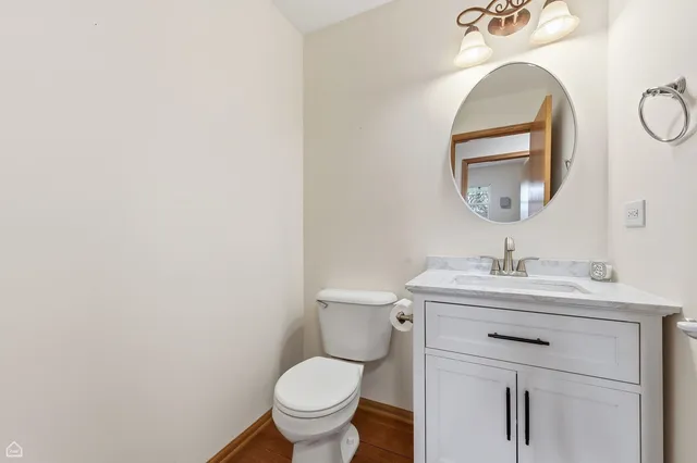 a bathroom with a toilet a sink and a mirror