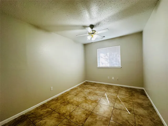 an empty room with a fan