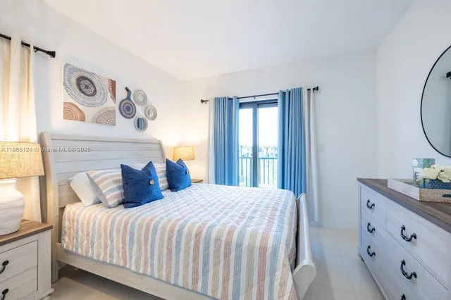 a bedroom with a bed and painting on the wall