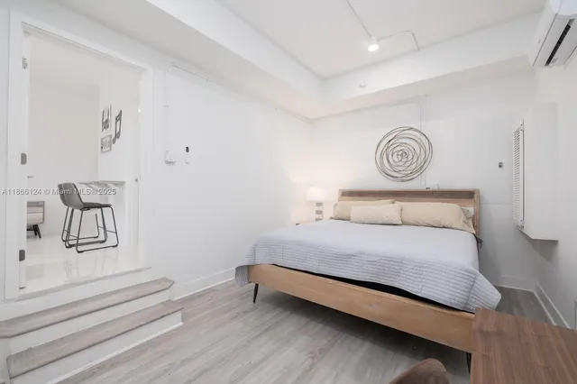 a bedroom with a bed and a chair