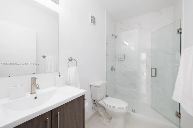 a bathroom with a sink toilet and shower