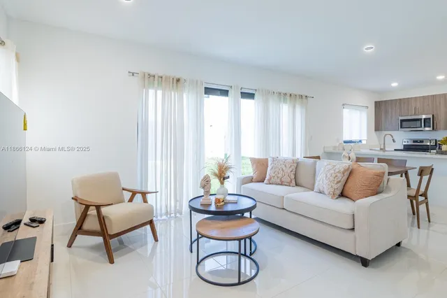 a living room with furniture and a large window