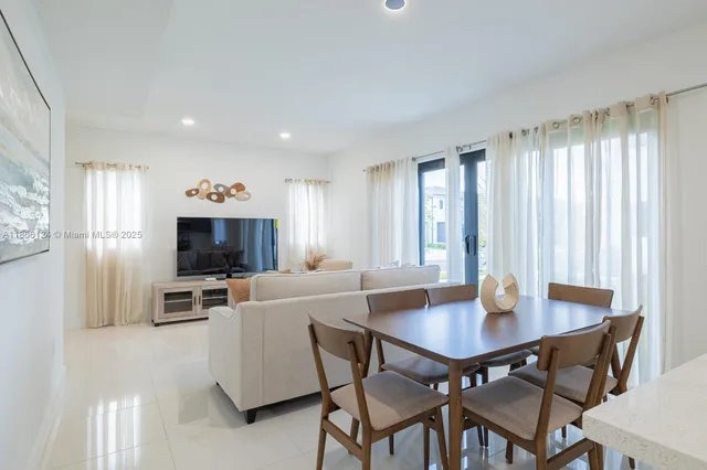 a view of a dining room with furniture and window