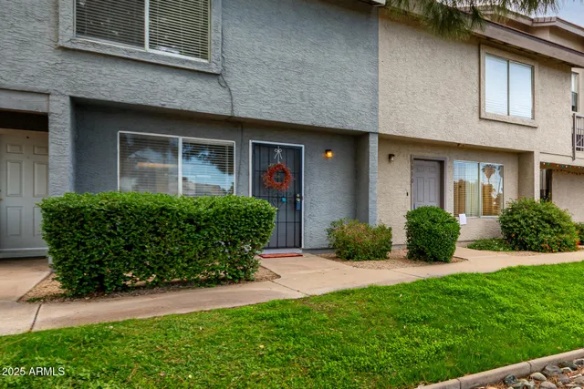 a view of a house with brick walls and a yard