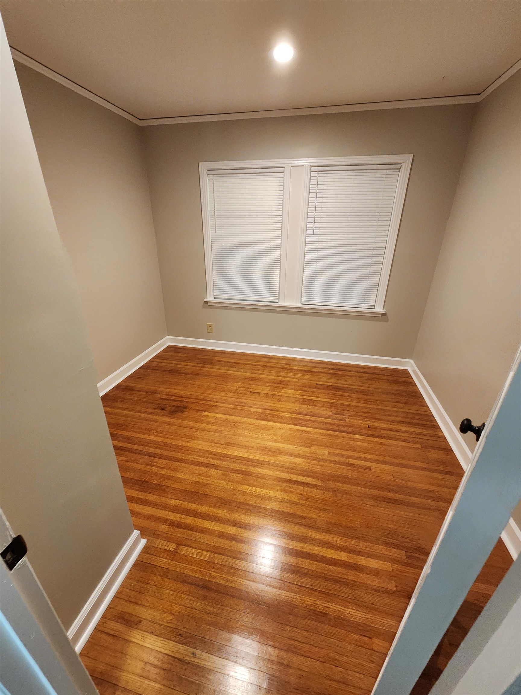 4624 Willow Road Memphis, TN 38117 - Photo 7 of 14 a view of an empty room with wooden floor and a window