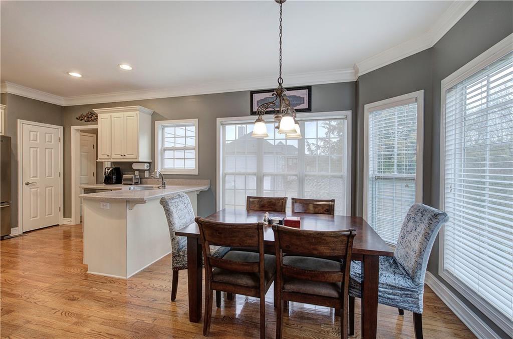 57 Colonial Circle Northwest Cartersville, GA 30120 - Photo 12 of 45 a dining room with furniture a chandelier and wooden floor