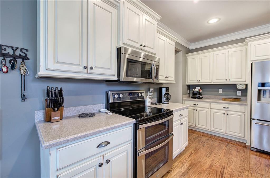 57 Colonial Circle Northwest Cartersville, GA 30120 - Photo 16 of 45 a kitchen with cabinets stainless steel appliances and a wooden floor