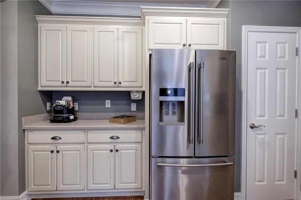 57 Colonial Circle Northwest Cartersville, GA 30120 - Photo 17 of 45 a kitchen with stainless steel appliances granite countertop a refrigerator sink and cabinets