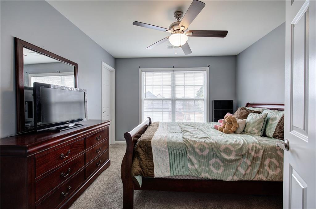 57 Colonial Circle Northwest Cartersville, GA 30120 - Photo 33 of 45 a bedroom with a bed and a flat screen tv