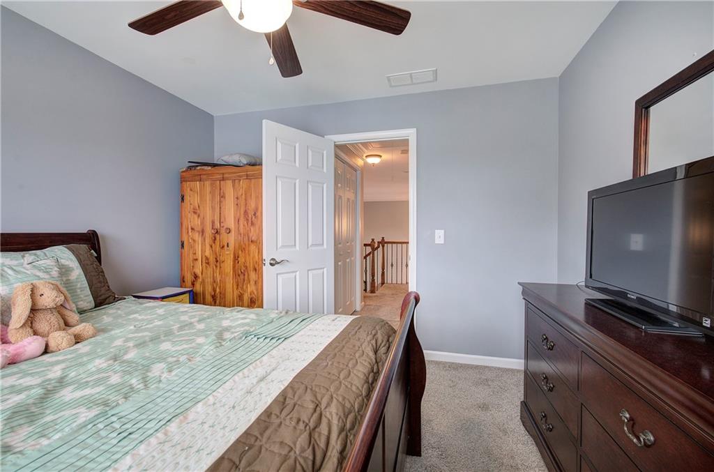 57 Colonial Circle Northwest Cartersville, GA 30120 - Photo 34 of 45 a bedroom with a bed and a flat screen tv