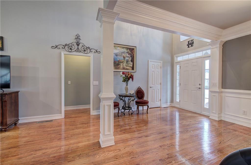 57 Colonial Circle Northwest Cartersville, GA 30120 - Photo 6 of 45 a view of a hallway with wooden floor windows a chandelier and living room view