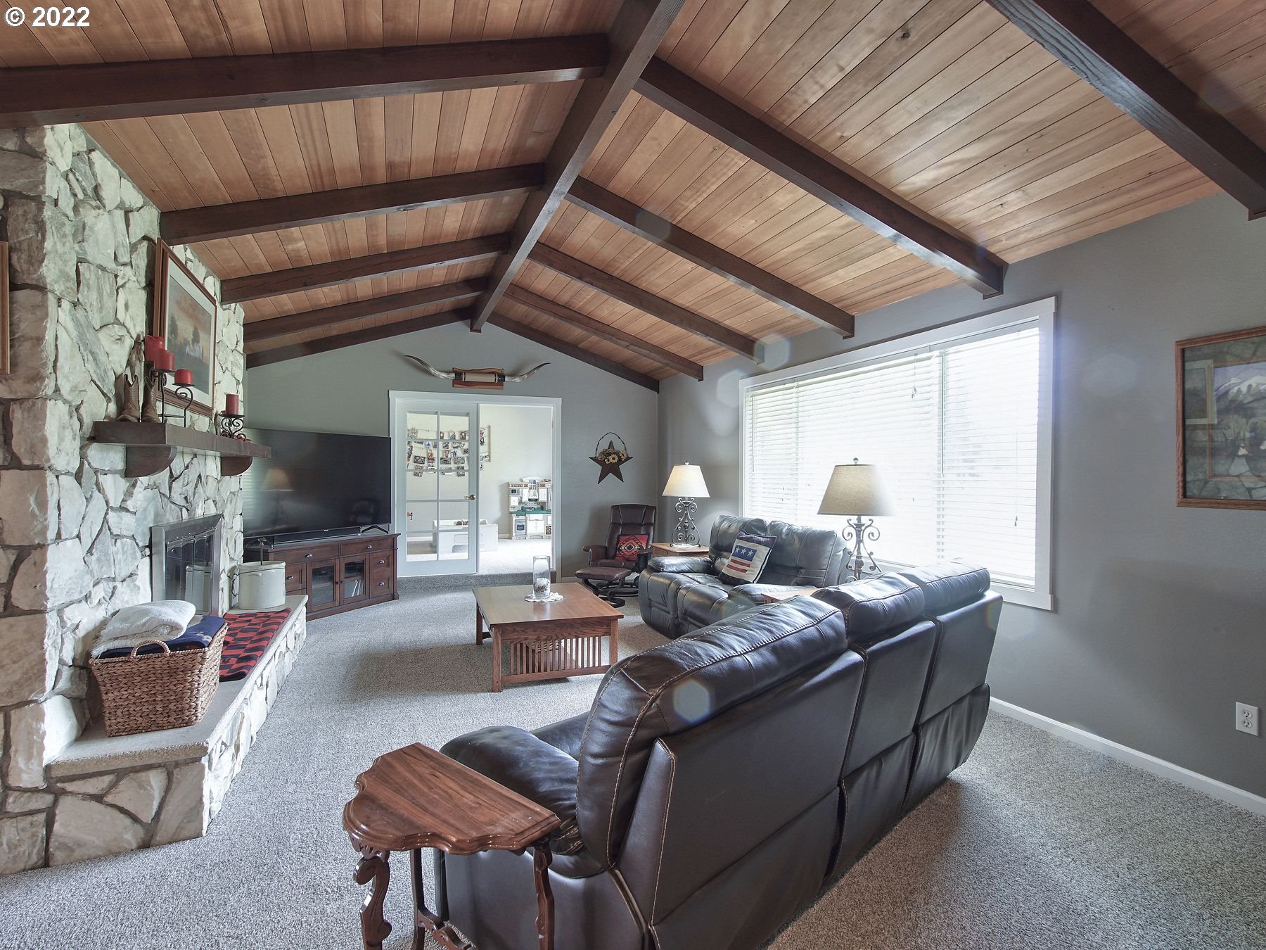 9960 Southwest Robinson Road Hillsboro, OR 97123 - Photo 2 of 31 a living room with furniture a fireplace and a table