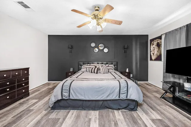 a bedroom with a bed and a flat screen tv