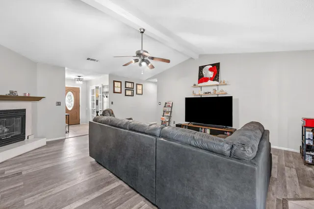 a living room with furniture a fireplace and a flat screen tv