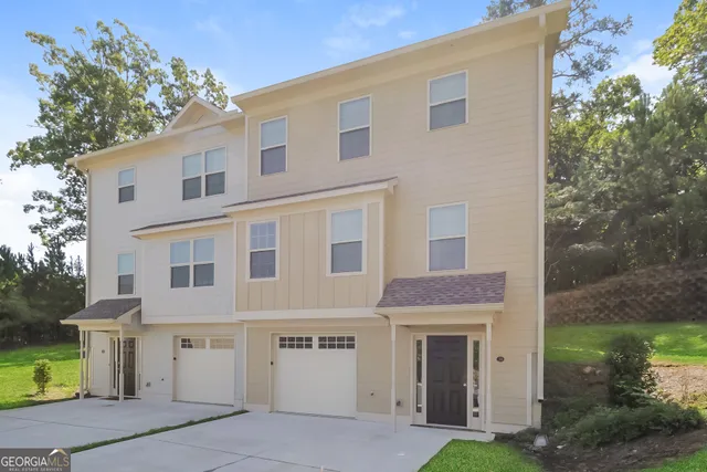a front view of a house with a garden