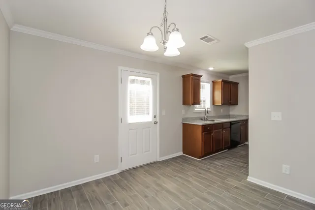 a view of kitchen with granite countertop cabinets and stove top oven