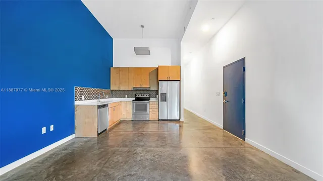 a kitchen with granite countertop a stove top oven and cabinets