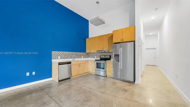 a kitchen with a refrigerator and stove
