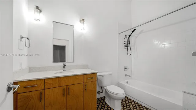 a bathroom with a sink toilet a mirror and shower