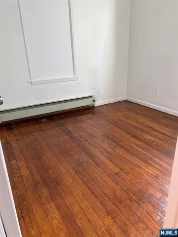 a view of room with wooden floor
