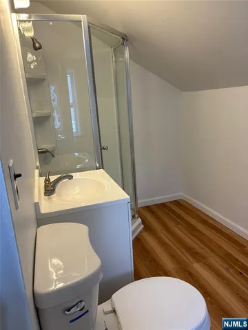 a bathroom with a sink a toilet a mirror and vanity