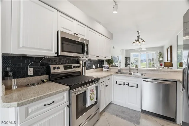 a kitchen with a sink stove and microwave