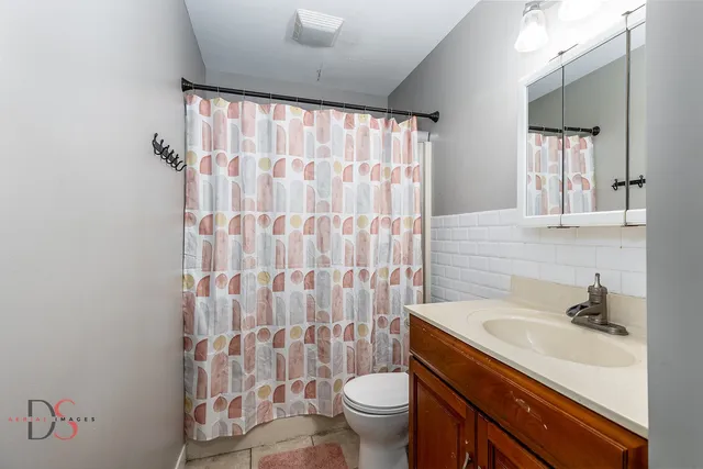 a view of walk in closet with clothes