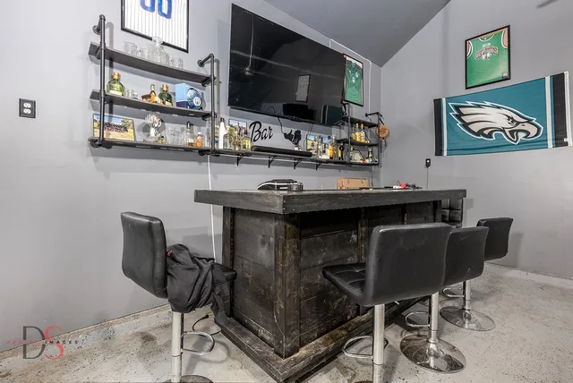 a backyard of a house with table and chairs