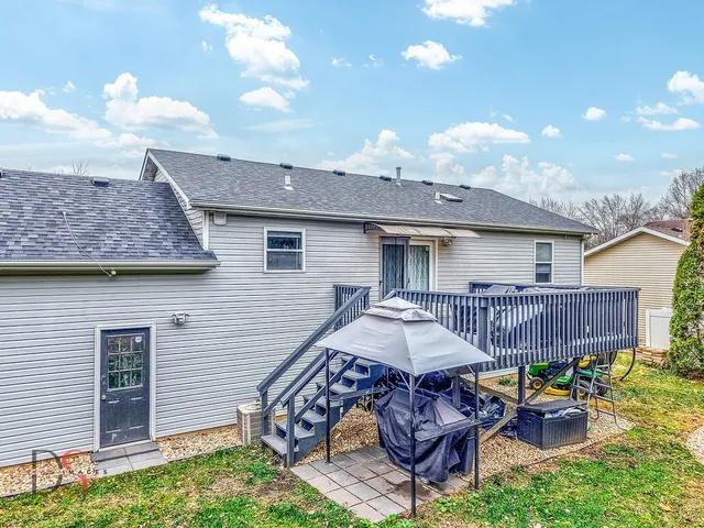 a backyard of a house with table and chairs