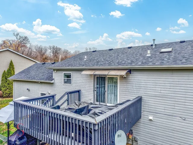 a view of a roof deck with furniture