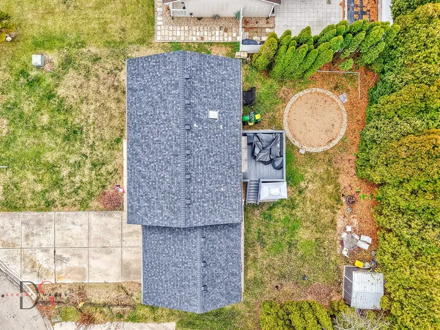 a backyard of a house with a trees and tree