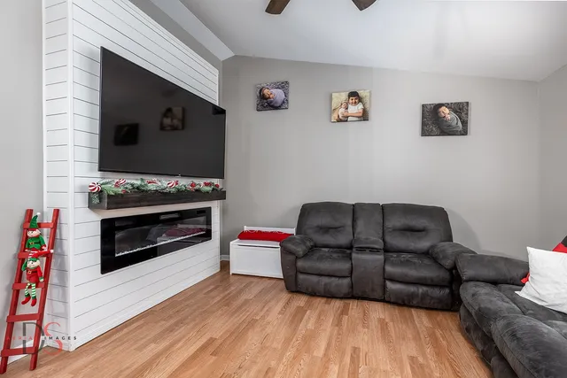 a living room with furniture and a fireplace