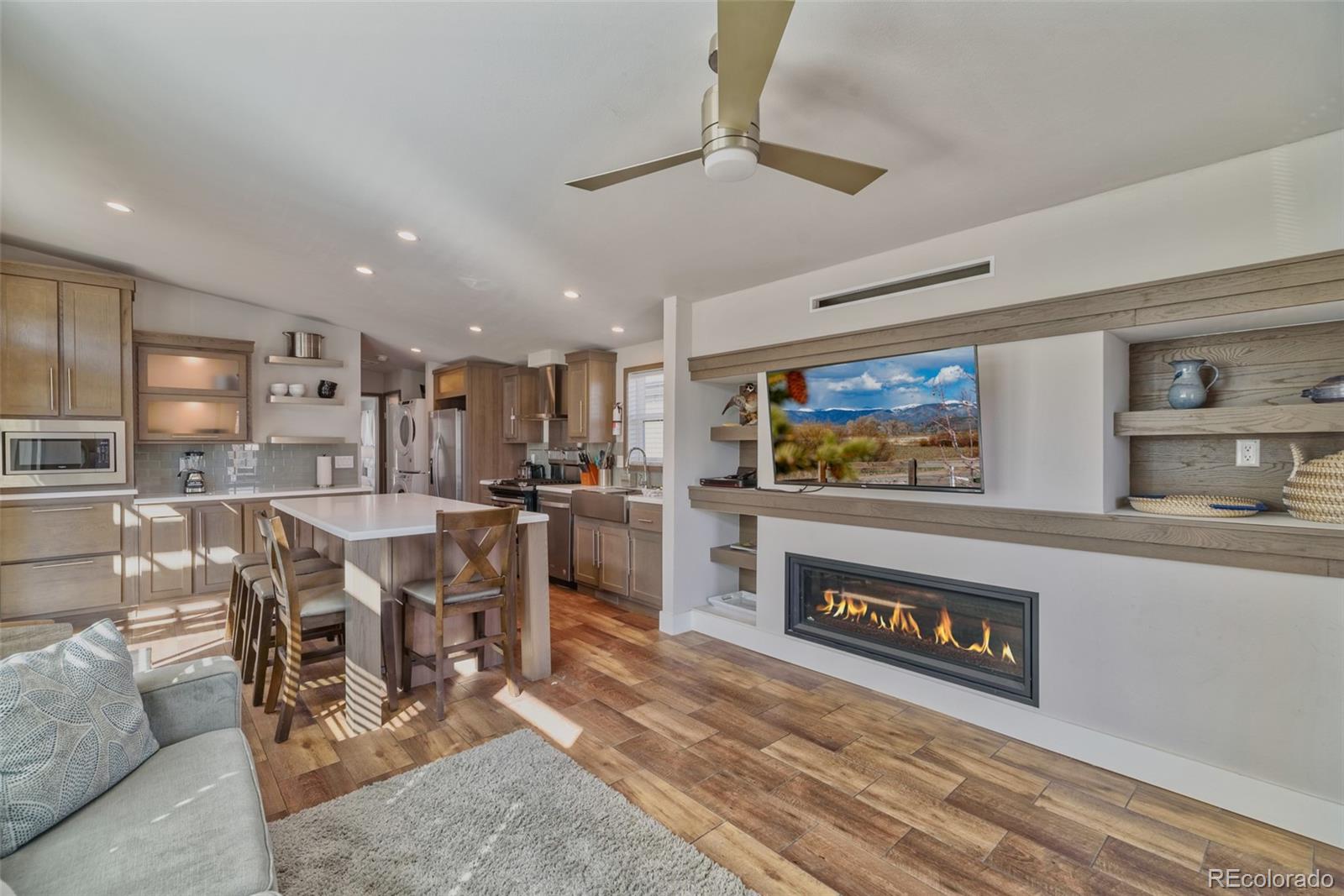 1051 Summit Trail Granby, CO 80446 - Photo 13 of 50 a living room with stainless steel appliances furniture a rug and a kitchen view