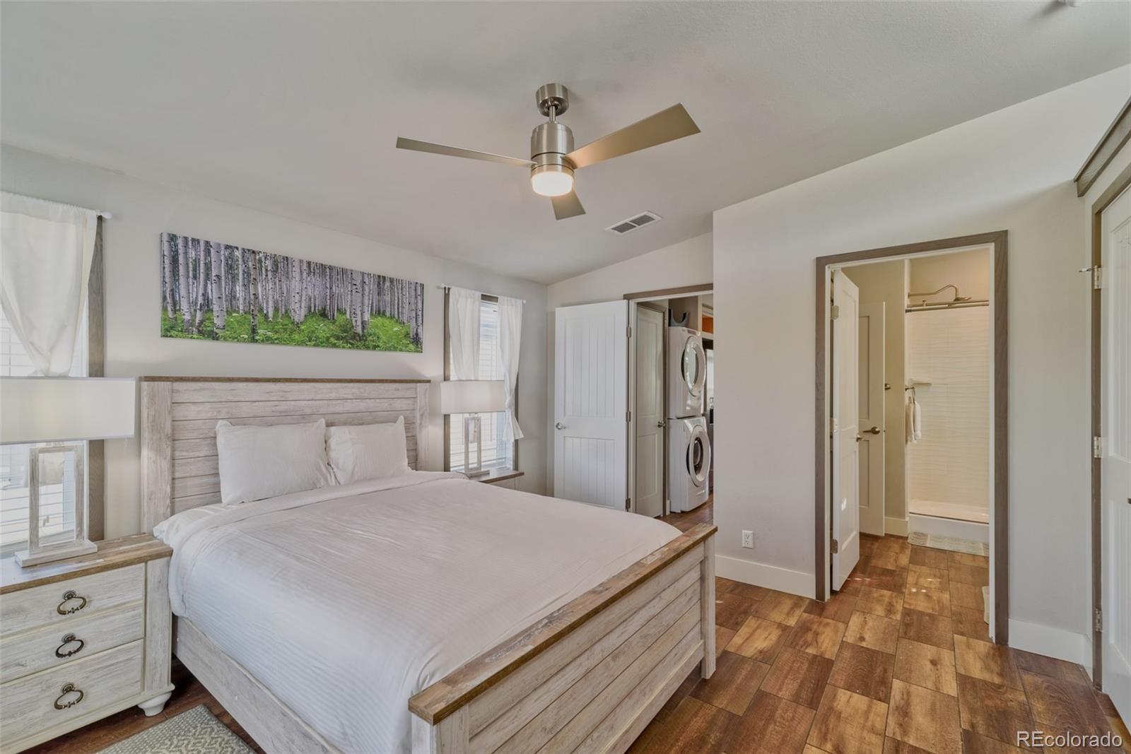 1051 Summit Trail Granby, CO 80446 - Photo 19 of 50 a bedroom with a large bed and a chandelier