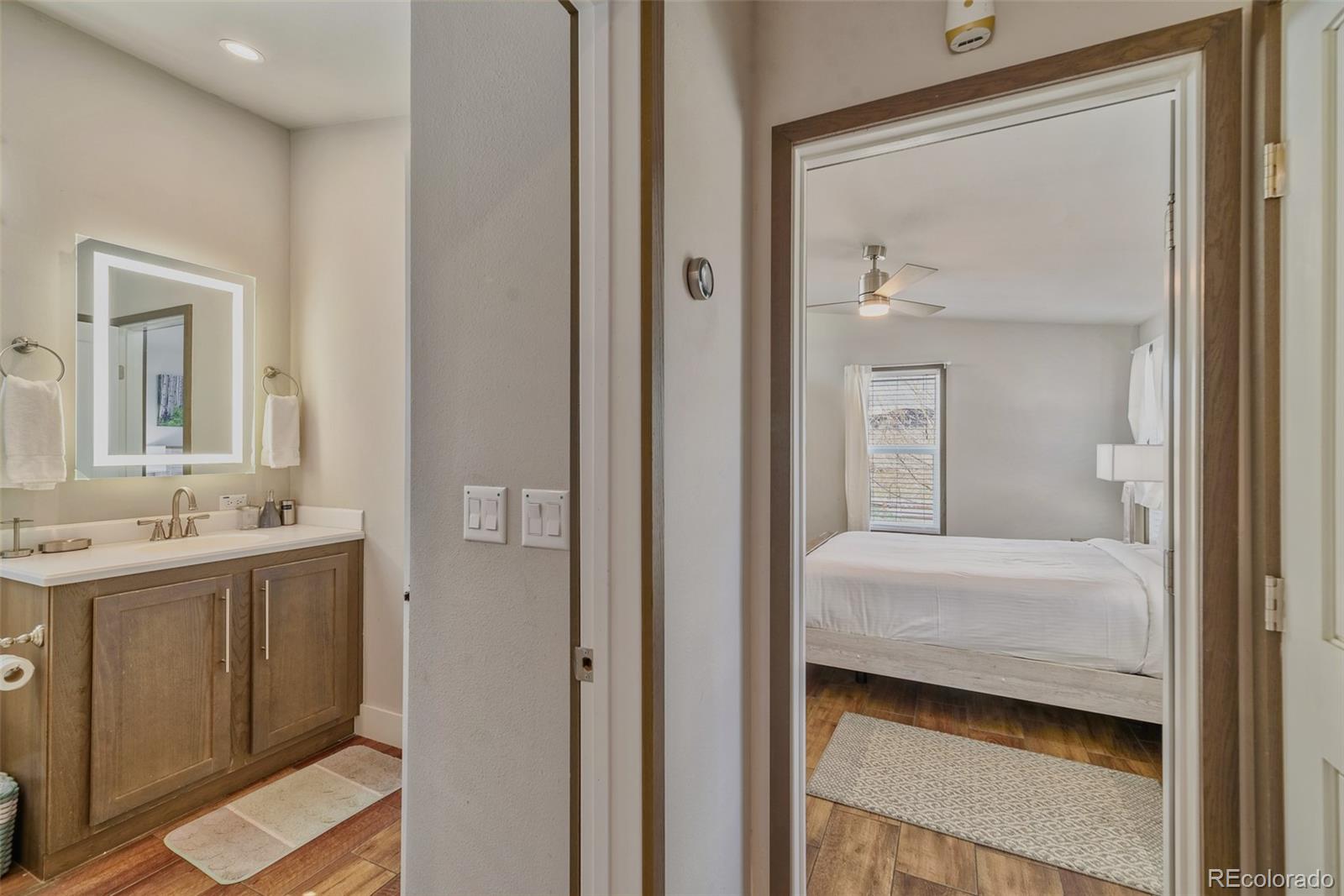 1051 Summit Trail Granby, CO 80446 - Photo 21 of 50 a en suite bathroom with a sink a mirror and a shower