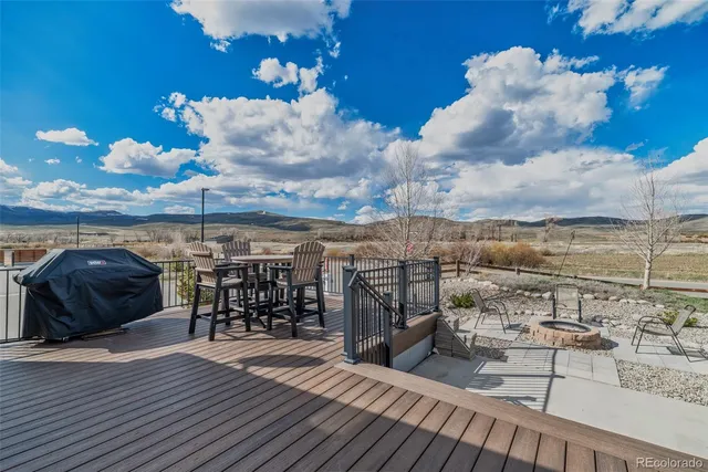 a table with wine bottles and sink on it