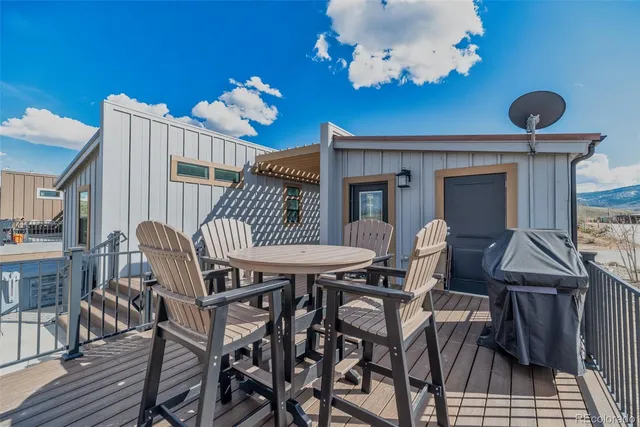 a view of a house with backyard and sitting area