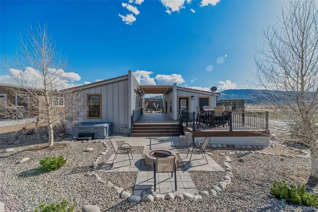 a backyard of a house with table and chairs