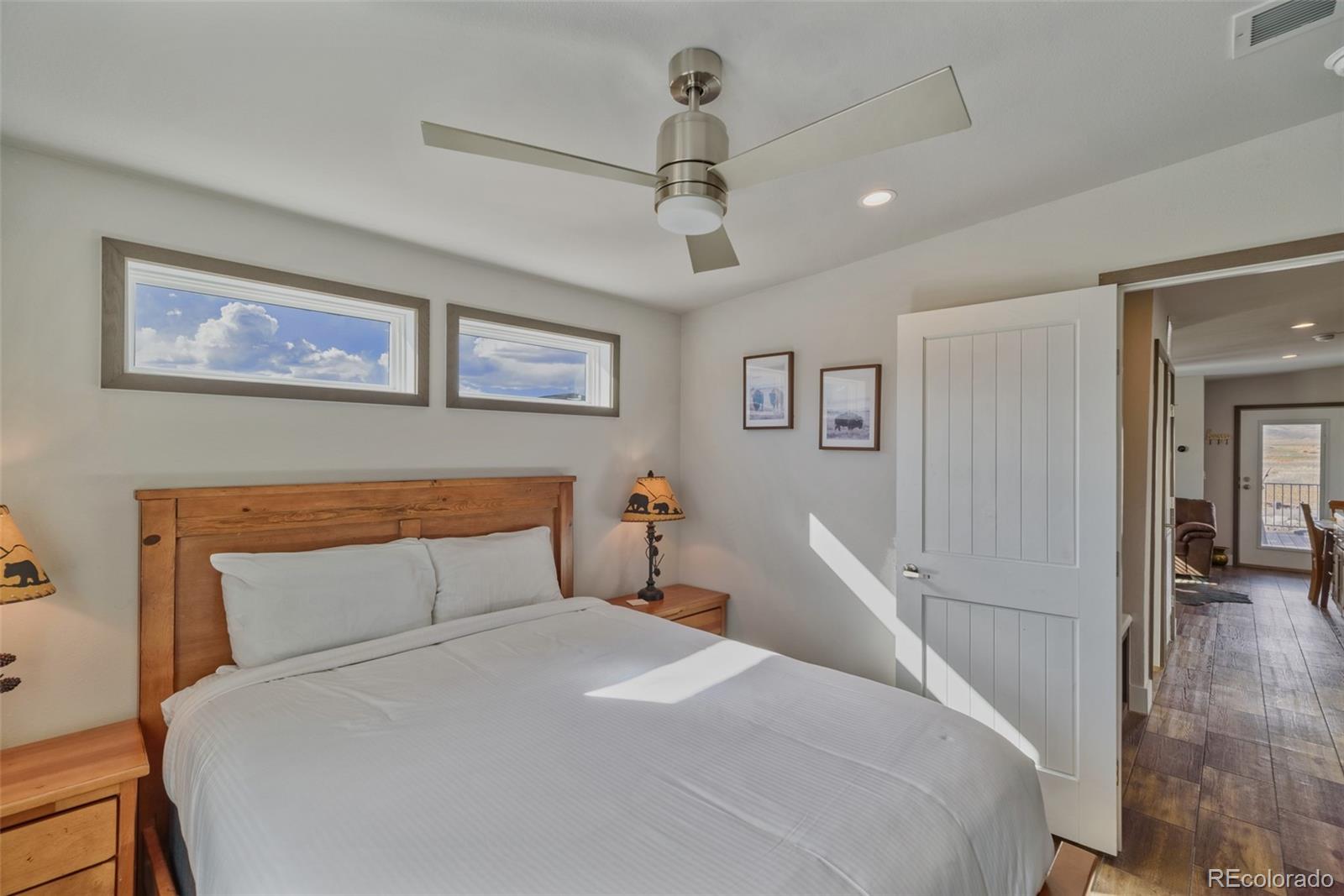 1051 Summit Trail Granby, CO 80446 - Photo 38 of 50 a bedroom with a large bed and a chandelier