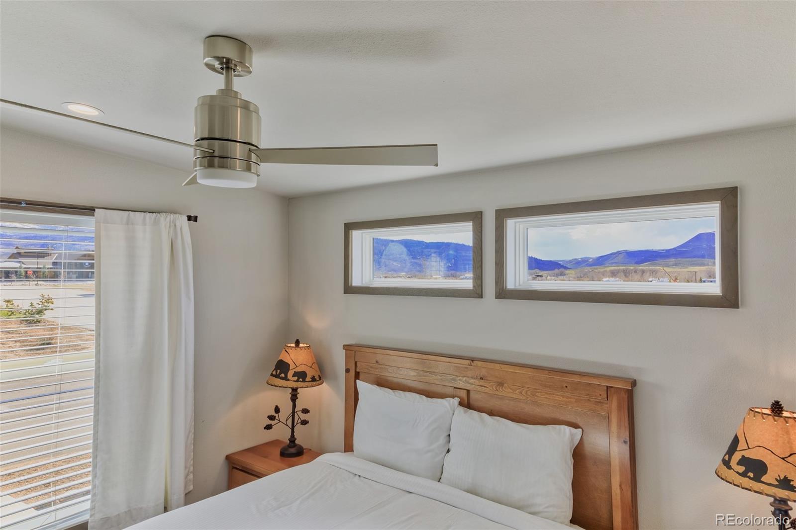 1051 Summit Trail Granby, CO 80446 - Photo 40 of 50 a bedroom with a bed and a chandelier