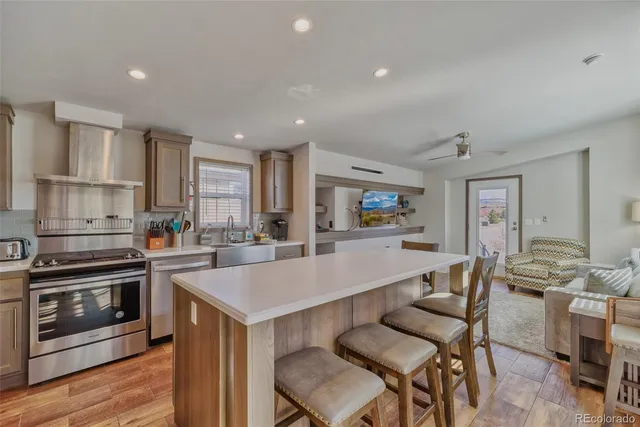 a kitchen with a refrigerator and a stove top oven