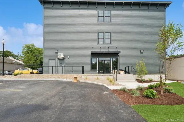 a view of a brick house with many windows