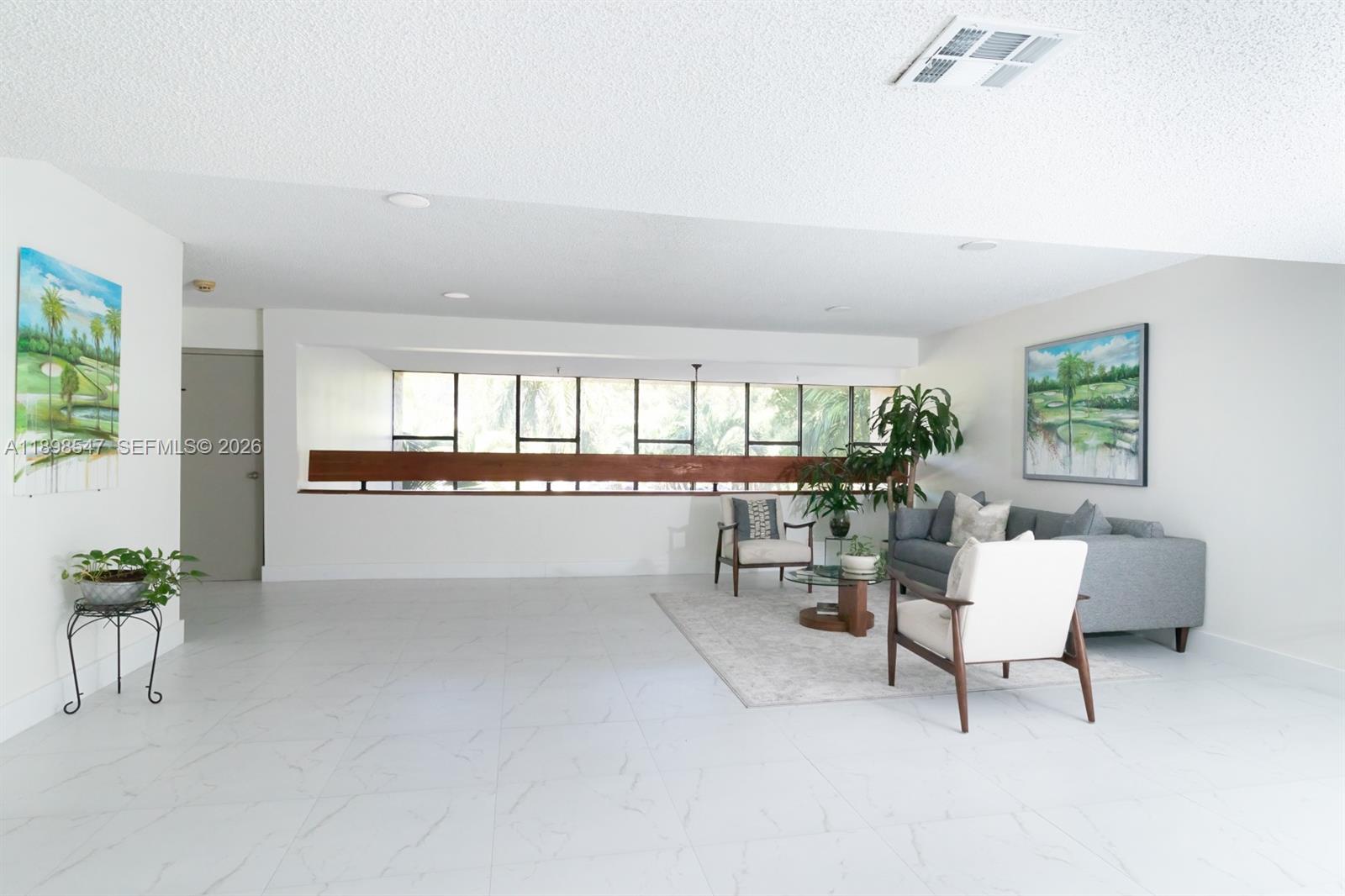 16200 Golf Club Road, Unit 312 Weston, FL 33326 - Photo 15 of 31 a living room with furniture and a large window