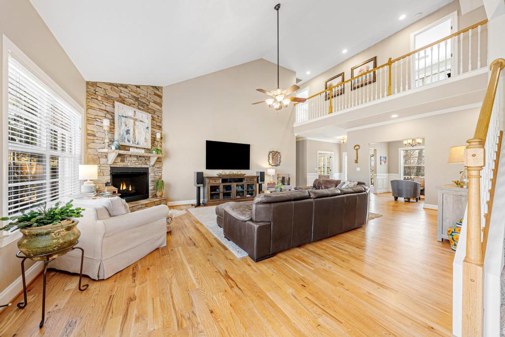 604 Feathery Lane Seneca, SC 29678 - Photo 14 of 44 This living room features high ceilings and an inviting fireplace, perfect for relaxation and gatherings.