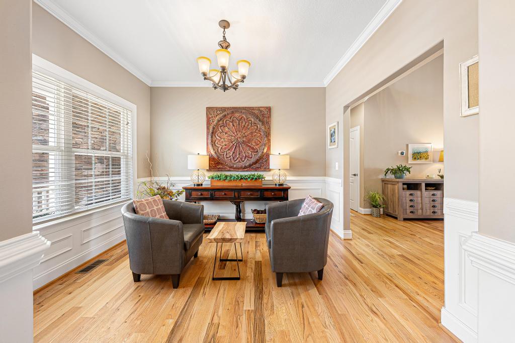 604 Feathery Lane Seneca, SC 29678 - Photo 18 of 44 This inviting space features lustrous hardwood flooring, elegant crown molding, and wainscoting.