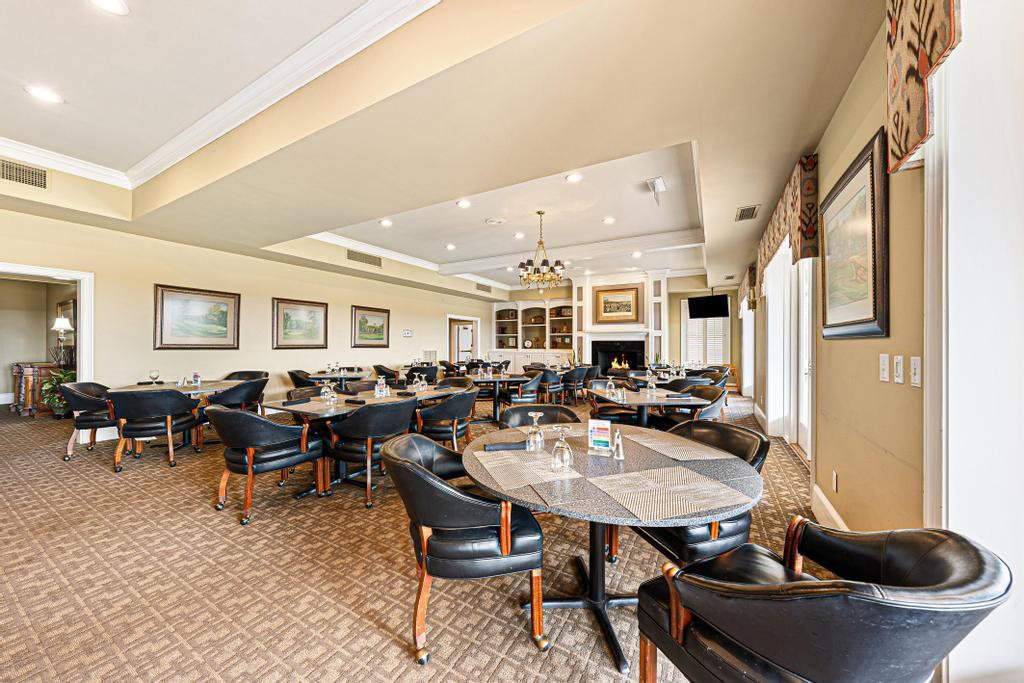 604 Feathery Lane Seneca, SC 29678 - Photo 39 of 44 This dining area features elegant furnishings and a cozy fireplace, perfect for entertaining.