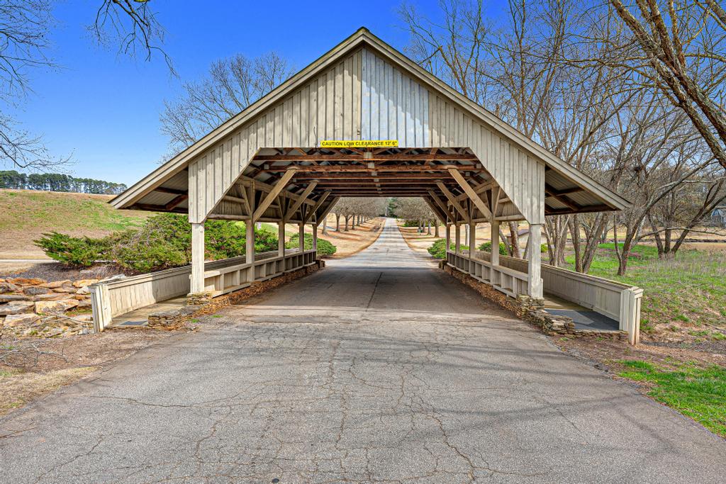604 Feathery Lane Seneca, SC 29678 - Photo 41 of 44 This charming covered bridge guides the way along a scenic drive through nature.
