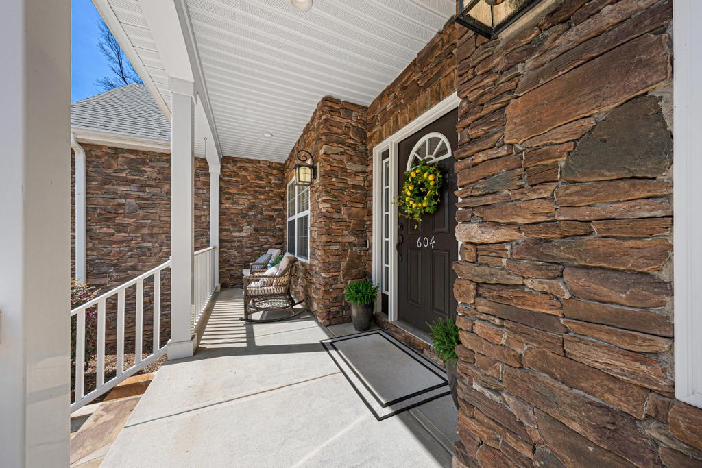 604 Feathery Lane Seneca, SC 29678 - Photo 6 of 44 This inviting porch, adorned with a stone facade, welcomes you home.